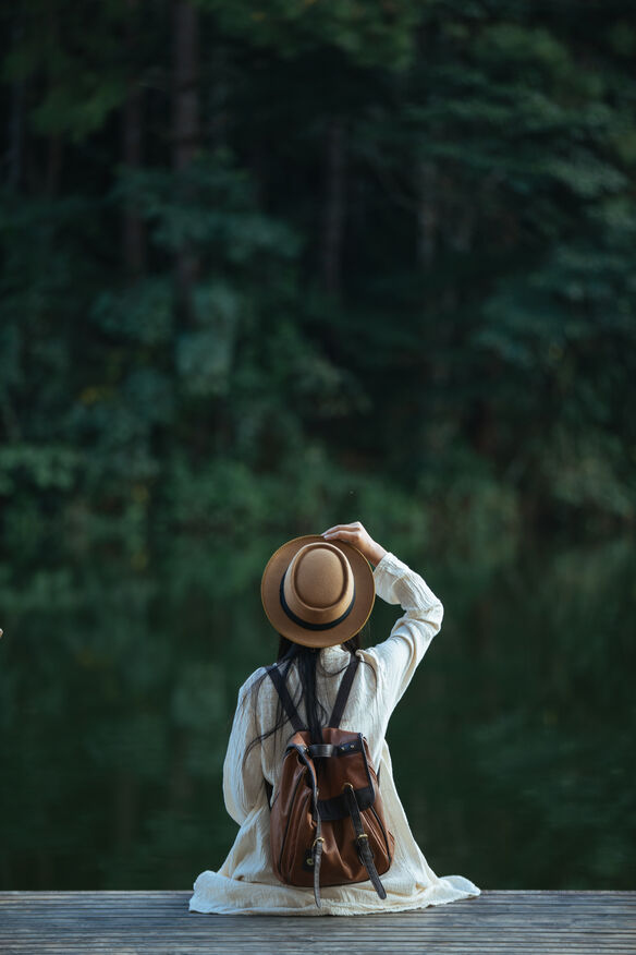 A beginner solo traveler walking confidently through a beautiful city street with a backpack, showing the freedom of traveling alone.